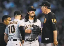  ?? David Zalubowski / Associated Press ?? Dereck Rodriguez talks to Evan Longoria and manager Bruce Bochy after taking an Ian Desmond liner off his right leg.