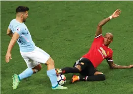  ??  ?? Ashley Young challenges Sergio Aguero in an incident which wasn’t deemed to be a foul by referee Martin Atkinson