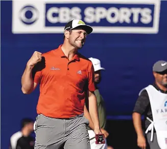  ?? GREGORY BULL/ASSOCIATED PRESS ?? Spain’s Jon Rahm exults after making a putt for eagle on the 18th hole, giving him a three-shot victory at the Farmers Insurance Open. He shot a final-round 67.