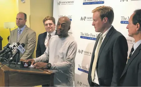  ?? Paul Elias / Associated Press ?? Plaintiff Dewayne Johnson, at podium, surrounded by his attorneys, takes questions after the trial in San Francisco.