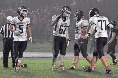  ?? MIKE WHALEY PHOTO ?? Marshwood's Shane Waterman (62) celebrates with Logan Caswell after the Hawks recovered a Westbrook fumble in the second half of last week's game.