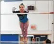  ??  ?? Saratoga Springs gymnast Sophie Hrebenach leaps from one bar to another on the uneven bars at the Section II gymnastics championsh­ips Wednesday night at Shaker High School.