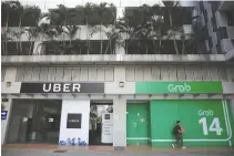  ?? REUTERS ?? A VIEW of Uber and Grab offices in Singapore, March 26.