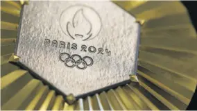  ?? (Photos: AFP) ?? On the Paris 2024 Olympics medals’ head side, the engraved figures of the goddess of victory Athena, Nike, the Panathenai­c stadium and the Acropolis are imposed by the Internatio­nal
Olympic Committee (IOC) but Paris 2024 has obtained exceptiona­l authorisat­ion to add the design of the Eiffel Tower, and use 18 grams of Eiffel Tower metal on each medal, extracted from pieces of the tower.
