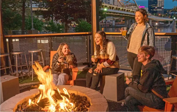  ?? Pittsburgh Post-Gazette ?? The fire pits outside Shorty’s Pins x Pints on the North Shore offer river views.