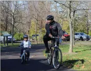  ?? PHOTO BY MICHILEA PATTERSON – FOR MEDIANEWS GROUP ?? A man and a little boy have a group ride on the Schuylkill River Trail at Pottstown Riverfront Park.