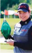  ?? — AFP ?? CAMBRIDGE: Ariya Jutanugarn of Thailand with the trophy after sinking her birdie putt on the 1st playoff hole to win during the final round of the Manulife LPGA Classic at Whistle Bear Golf Club on Monday in Cambridge, Canada.