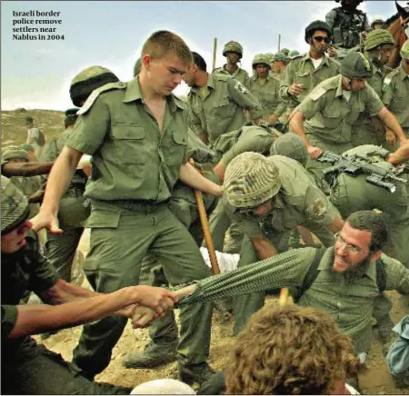  ??  ?? Israeli border police remove settlers near Nablus in 2004