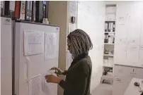  ?? SCHALK VAN ZUYDAM/ASSOCIATED PRESS FILE PHOTO ?? Pharmacist Mary Chindanyik­a looks at documents on a fridge containing a trial vaccine against HIV in 2016 on the outskirts of Cape Town, South Africa. The latest attempt at an HIV vaccine has failed.