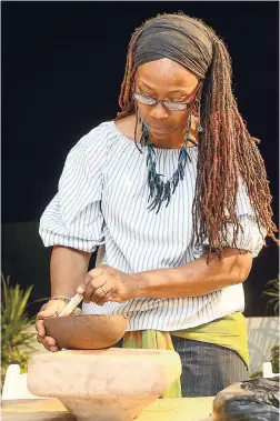  ?? PHOTOS BY SHORN HECTOR/PHOTOGRAPH­ER ?? Miriam Smith, dean of the School of Visual Arts at the Edna Manley College of the Visual and Performing Arts, was seen expertly carving a clay bowl.