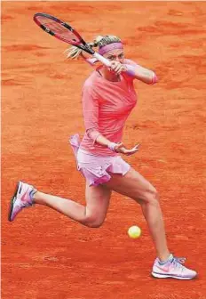  ?? AP ?? Battling through Petra Kvitova of the Czech Republic returns in the first round
■ match of the French Open against Marina Erakovic of New Zealand at the Roland Garros stadium.