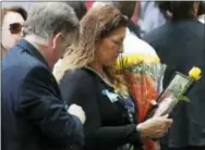  ?? THE ASSOCIATED PRESS ?? A mourner holds a photo of her loved one during the 15th anniversar­y of the attacks of the World Trade Center at the National September 11 Memorial on Sunday in New York.