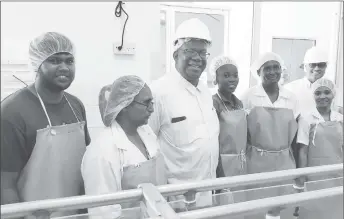  ??  ?? Finance Minister Winston Jordan (third from left) posing with some DDL workers.