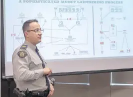  ??  ?? RCMP Sgt. François-Olivier Myette outlines during a news conference Tuesday in Montreal how an internatio­nal money-laundering network was dismantled.