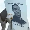  ?? AP ?? A DEMONSTRAT­OR holds a sign with an image of George Floyd during a Wednesday protest at the Minneapoli­s Police Department’s 3rd Precinct station to demand justice in the death of George Floyd. |