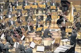  ?? Kent Nishimura Los Angeles Times ?? THE L.A. PHIL performs “Threshold” by its principal timpanist, Joseph Pereira.