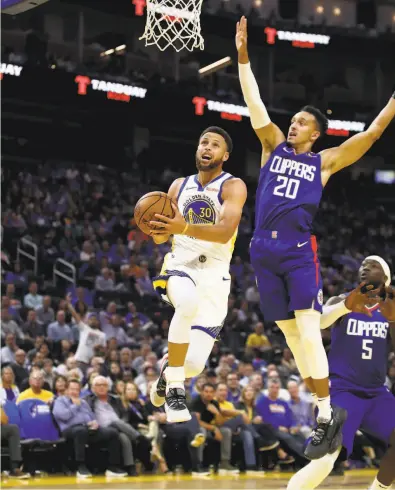  ?? Ezra Shaw / Getty Images ?? Landry Shamet was among the Clippers players who shadowed Warriors guard Stephen Curry on Thursday.