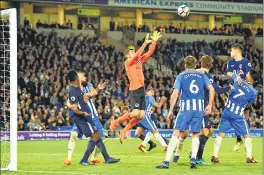  ??  ?? Brighton's goalkeeper Mathew Ryan (C) jumps to make a save against Tottenham Hotspur during the English Premier League football match at the American Express Community Stadium in Brighton.