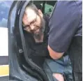  ?? TENNESSEE HIGHWAY PATROL VIA AP ?? Steven Wiggins is detained by officers on Friday in Hickman County, Tenn. Wiggins, suspected in the fatal shooting of a Tennessee sheriff’s deputy during a traffic stop, was arrested after a two-day manhunt.