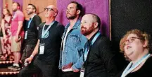  ??  ?? One of the 2018 deadCenter Film Festival’s Oklahoma Film Icon winners, Ryan Merriman, center, watches a highlight reel June 8 before the screening of “The Jurassic Games” at Harkins in Bricktown. With him are, left, deadCenter Executive Director Lance...