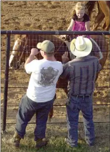  ?? MARK HUMPHREY ENTERPRISE-LEADER ?? Heidi Rust, 8, gets some advice from her grandfathe­r, Bruce Napier. As a 3-year-old, Rust placed second in the all-around barrels at Grove, Okla., in rodeo competitio­n. Her mother, Beverly Napier, said she was born in the saddle.