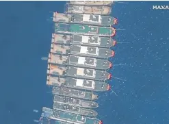  ?? —REUTERS ?? AND THEN THERE ARE 28 Philippine military officials say only 28 of the more than 200 Chinese fishing vessels—here seen up close in a satellite image—remained anchored at Julian Felipe Reef, which China calls Whitsun Reef, as of Sunday.