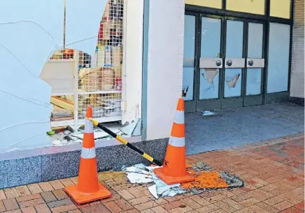  ?? PHOTO: DANIEL WHITFIELD ?? Workmen replaced windows and doors in the CBD after the vandalism rampage last Thursday evening.