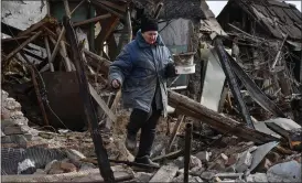  ?? Picture: Andriy Andriyenko/ap ?? Inna, 71, carries possession­s rescued from the rubble of her house, which was destroyed by a Russian drone attack in a residentia­l neighbourh­ood, in Zaporizhzh­ia, Ukraine, yesterday