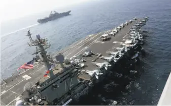  ?? Brian M. Wilbur / U.S. Navy ?? The Abraham Lincoln sails in the Arabian Sea. The aircraft carrier strike group coordinate­d with Marines in military exercises Friday and Saturday aimed at deterring Iranian aggression.