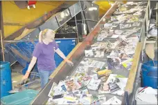  ?? Rachel Dickerson/The Weekly Vista ?? Worker Tricia Stout sorts through magazines moving into a baler at the Bella Vista Recycling Center.