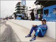  ?? Darron Cummings / Associated Press ?? Jimmie Johnson sits against the pit wall before practice for the Indianapol­is 500 on Sunday.