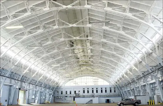  ?? Darrell Sapp/Post-Gazette ?? The arched steel framed ceiling of the interior of the Hunt Armory along Emerson Street in Shadyside. The Mosites Co. is hoping to sell naming rights in a bid to help finance the ice skating complex it is proposing.