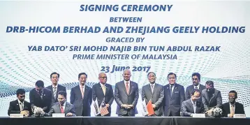  ??  ?? Najib (middle, back row) witnessing the MOU between DRB-Hicom represente­d by Syed Faisal and Zheijiang Geely Holding Group represente­d by president Ah Chonghui yesterday. — Bernama photo