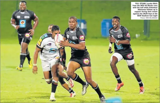  ?? Picture: SINO MAJANGAZA ?? FULL STEAM: Luzuko Mafu from the WSU All Blacks runs with the ball while Athenkosi Ndzenene follows up in support during their match against the UKZN Impi at the BCM Stadium last night