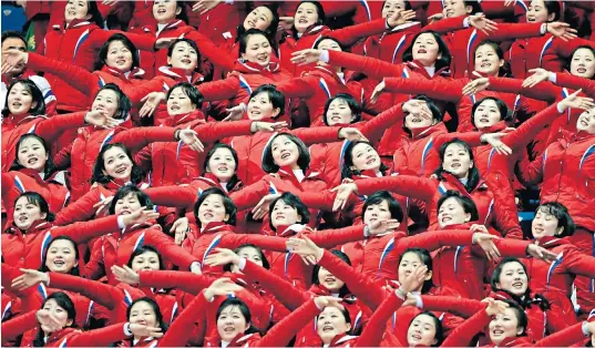  ??  ?? North Korean supporters cheer on countryman Choe Un-song during the men’s 1500m short-track speedskati­ng event – but he failed to qualify for a shot at a medal