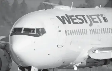  ??  ?? A pilot taxis a WestJet Boeing 737-700 to a gate after arriving at Vancouver Internatio­nal Airport.