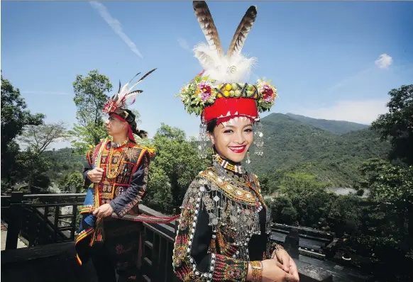  ?? DAVID CONACHY ?? Ljavuas and Makueskes, from the Paiwan tribe, wear wedding clothes for engagement photos at the Indigenous Peoples’ Cultural Park in southern Taiwan in April.