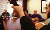  ?? CHRIS SWEDA / CHICAGO TRIBUNE ?? Doug Brown (second from right), a resident of Silverado Memory Care near Chicago, plays the guitar during a music therapy program earlier this year for people with dementia and Alzheimer’s disease. A new study links viruses to Alzheimer’s.