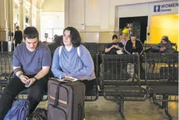  ??  ?? Top: The Greyhound bus station main entrance in Oakland, where riders said they were not happy to hear that federal immigratio­n agents were questionin­g bus riders. Above: Kamryn Bauersfeld of Santa Barbara waits with her boyfriend in Oakland for a San...
