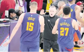  ?? AP ?? Denver Nuggets head coach Michael Malone ( centre) shakes hands with Denver Nuggets centre Nikola Jokic (15) and guard Jamal Murray (27) in the second half of Game 3 of the NBA Western Conference Final series against the Los Angeles Lakers on Saturday in Los Angeles.