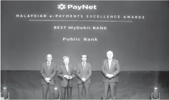  ??  ?? (From left) PayNet chairman Datuk Ahmad Hizzad, Tay, Adnan and Peter Schiesser, Group CEO of PayNet at the Malaysian e-Payments Excellence Awards.