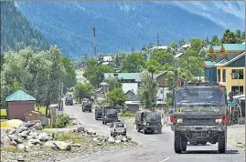  ??  ?? An army convoy moves along the Srinagar-Leh National highway on June 17, 2020. Twenty army personnel were killed during a clash with China in Galwan Valley on June 15.