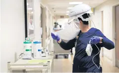  ?? NYT ?? A nurse at Sarasota Memorial Hospital in Sarasota, Florida, removes protective equipment after seeing a patient who is in isolation, earlier this month.