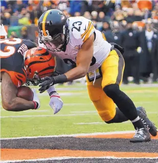  ?? FRANK VICTORES/ASSOCIATED PRESS ?? Pittsburgh survived a scare against Cincinnati last week, which was led by Jeremy Hill (32), who is shown scoring in front of Steelers safety Mike Mitchell (23).