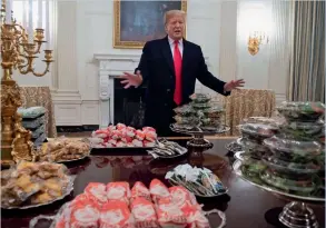  ?? AFP ?? trump speaks alongside fast food he purchased for a ceremony honouring the 2018 College football playoff National Champion Clemson tigers at the white house in washington. —