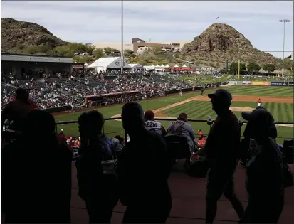  ?? DARRON CUMMINGS — THE ASSOCIATED PRESS ?? Fans watch a spring training game between the Angels and Padres on Feb. 27in Tempe, Ariz.