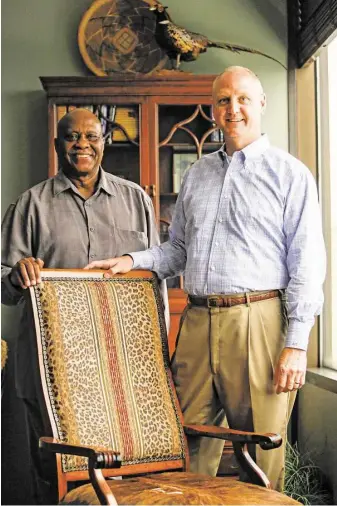  ?? Eric Kayne ?? Retired teacher H.B. Taylor, left, admires the upholstere­d chair made by former student Gil Baumgarten. Recently, Baumgarten sent Taylor on a trip to Greece as a way to say thank you.