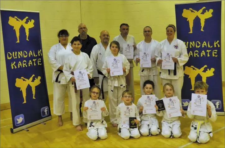  ??  ?? Head of Dundalk Karate, Sensei Mary Marcus 3rd Dan with Sensei Stephen Hughes 5th Dan and Sensei Mark Murphy with members of Dundalk Karate who sucessfull­y graded.