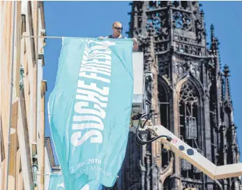  ?? FOTO: DPA ?? „ Suche Frieden“: Eine Flagge am Prinzipalm­arkt in Münster kündet vom Motto des 101. Katholiken­tages.