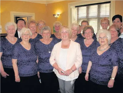  ??  ?? Suzy Davies AM, Shadow Cabinet Secretary for Social Services, at the Bridgend Carers Centre event organised to mark Carers Week. Also pictured are members of Côr Merched Cwm Llynfi who provided the entertainm­ent